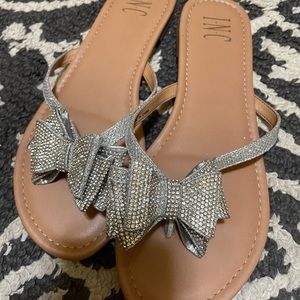 I.N.C flip flops. Features glitter bow detail. Size 8.